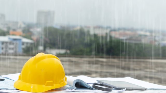 A picture of a bricklayers hat in front of a rainy background